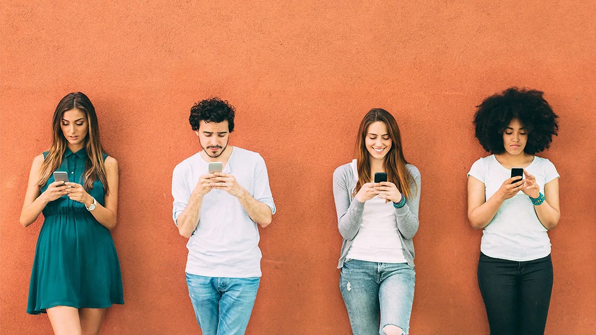 young people looking at their phones