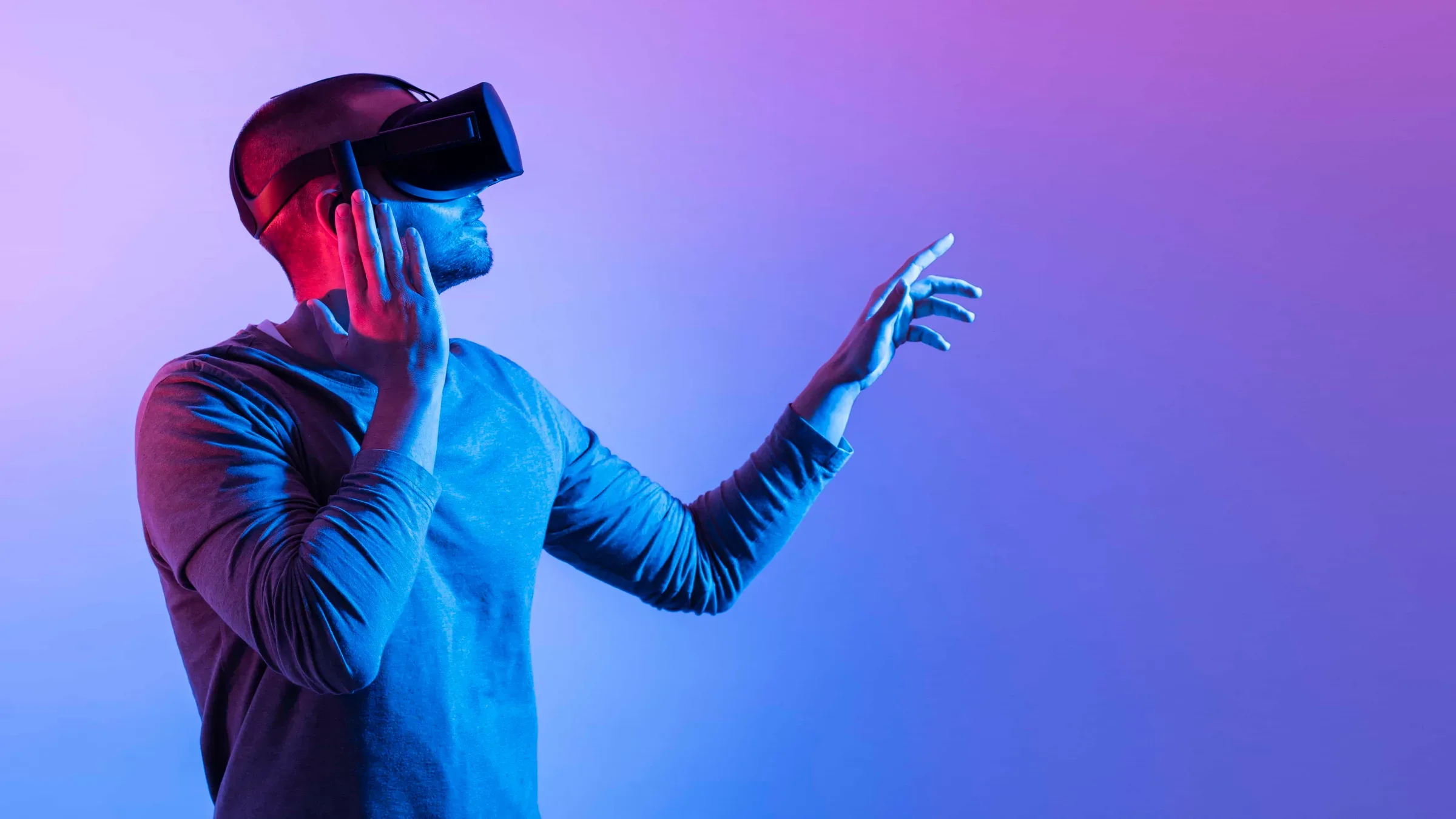 man with futuristic device pointing up