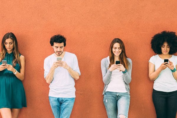 young people looking at their phones