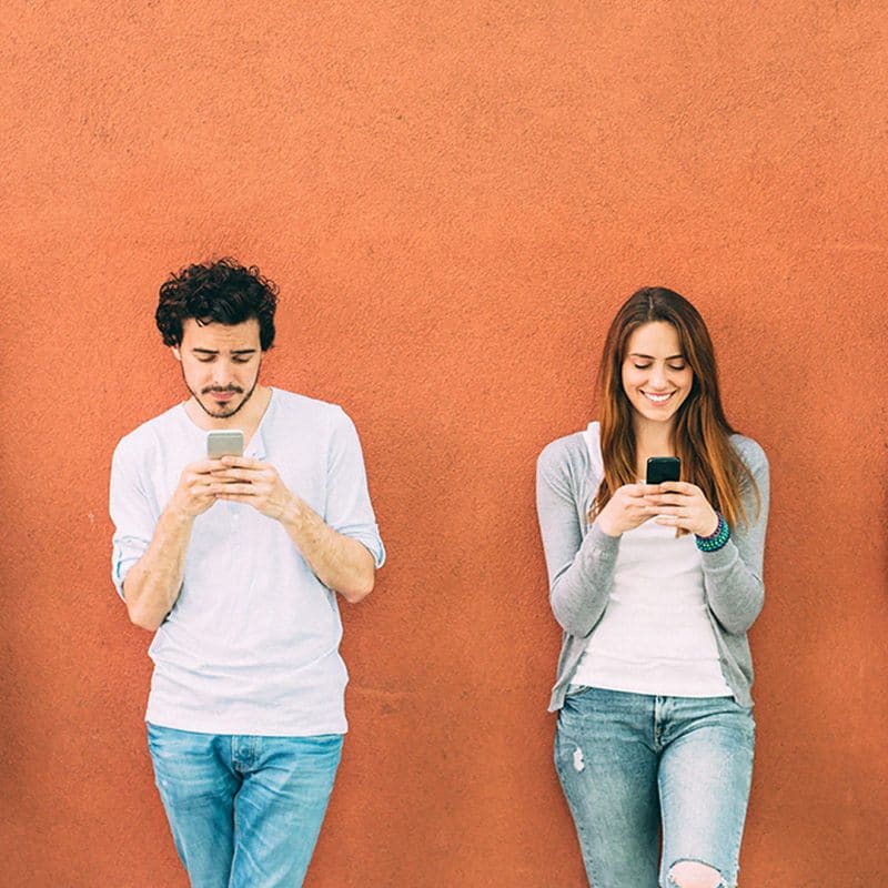 young people looking at their phones