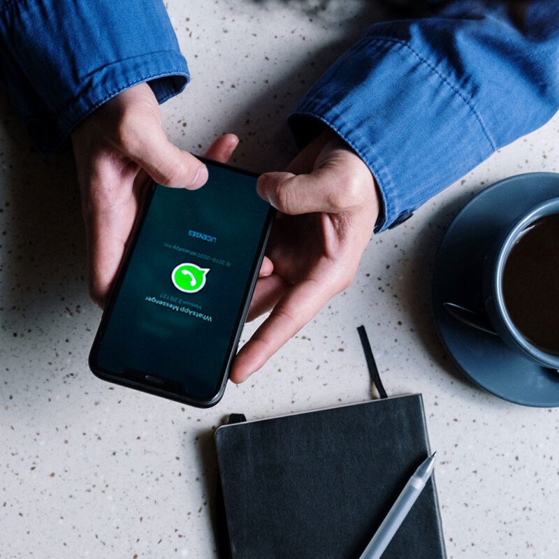 pessoa com telemóvel a aceder ao whatsapp